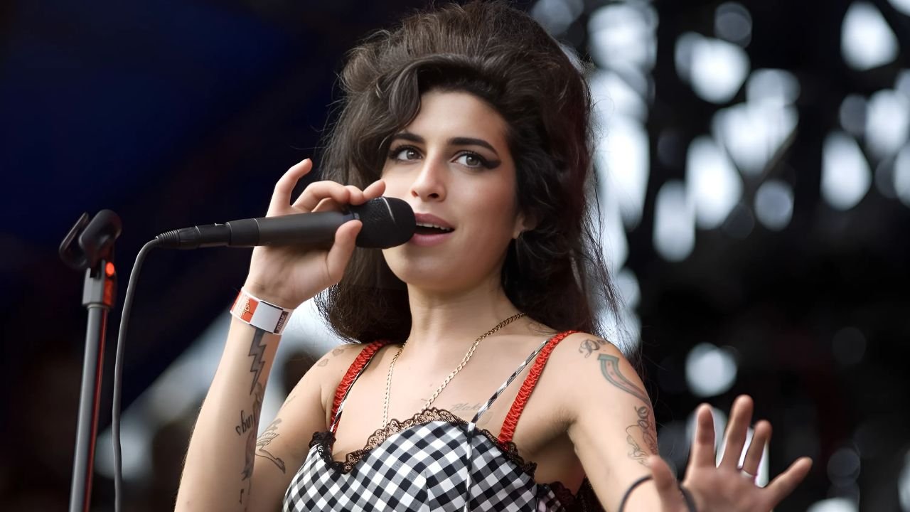 Amy Winehouse performing with raw intensity, hair in beehive, eyes closed
